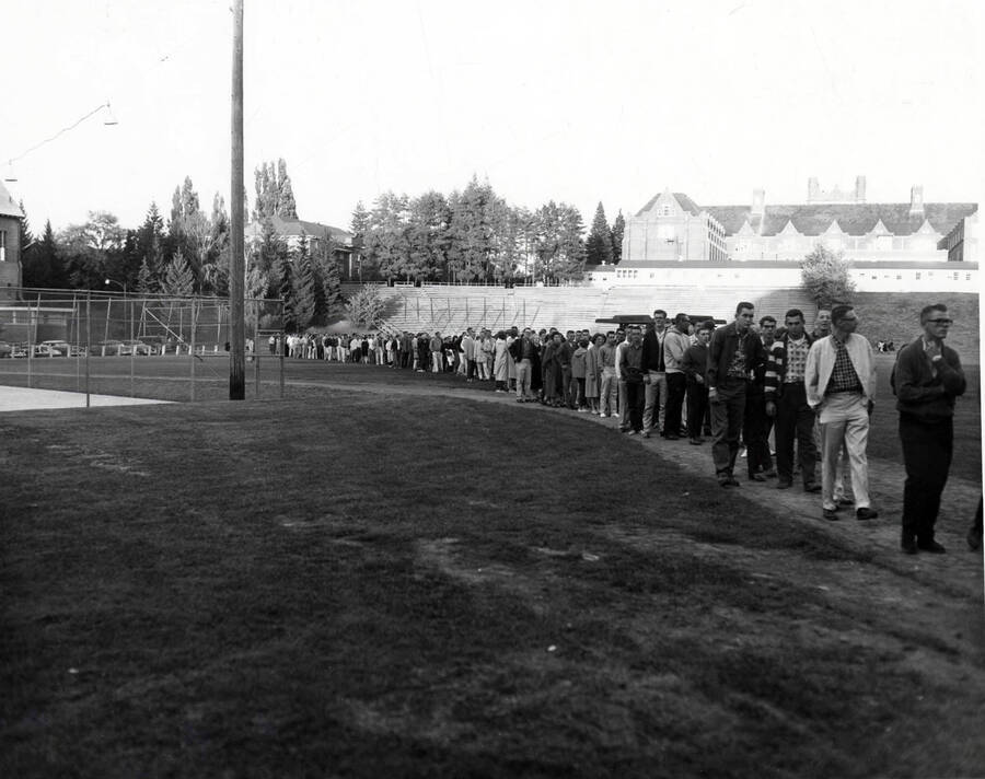 Line of students waiting for food at the all campus barbecue, located in the old arboretum.