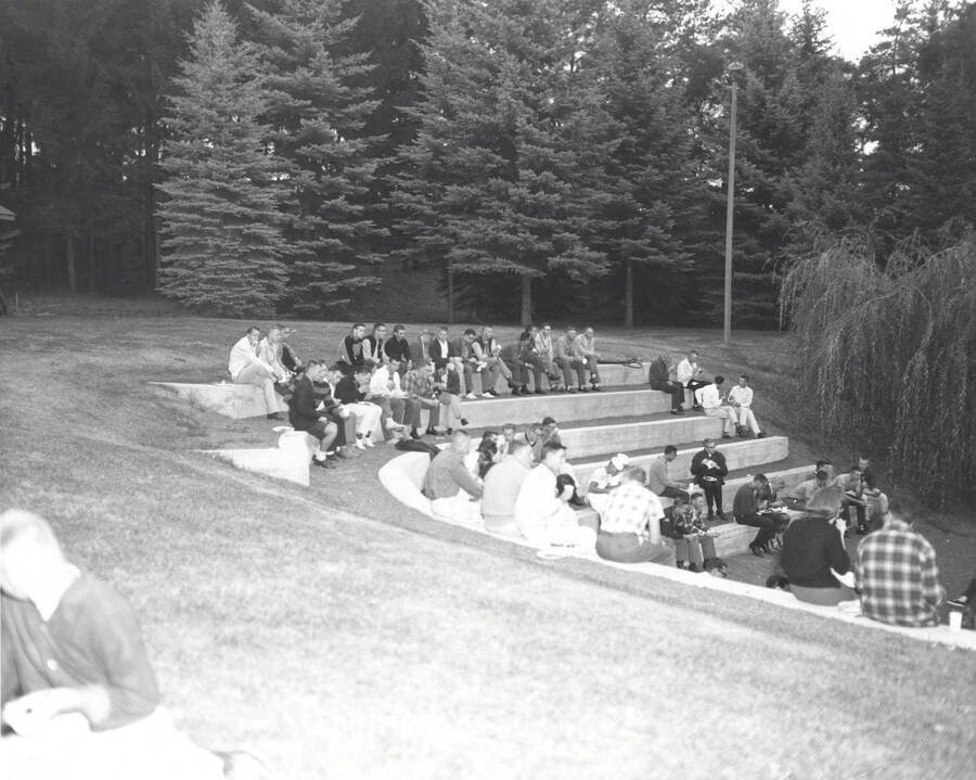 Students sit and eat together at the all campus barbecue, located in the arboretum.