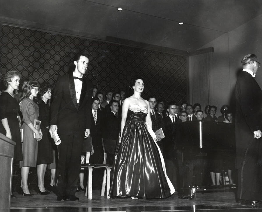 Soloists Phyllis Goecke and Charles K. Sims stand on stage during a University Singers concert. Selections from 'A German Requiem' were presented.