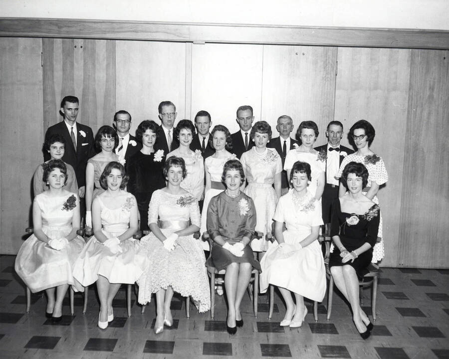 Phi Beta Kappa honors society pose for a group photo while wearing formal wear.