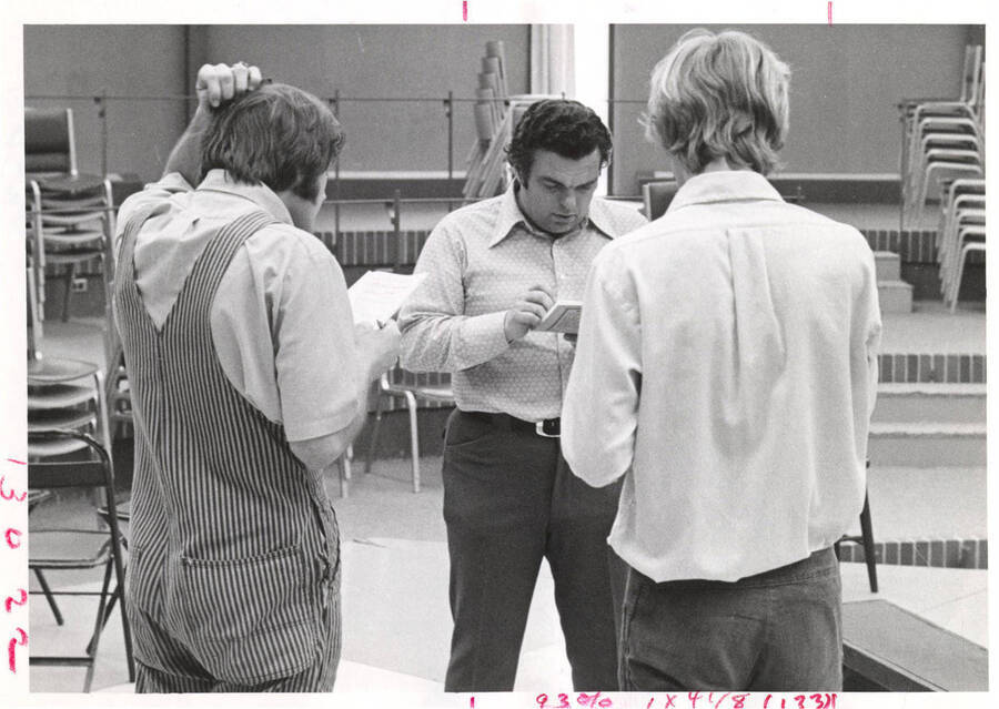 Professor Forest Sears [Center] and two theater students read lines in the theatre department. Sears was an acting/directing professor in the KIVA from 1969 to 1973.