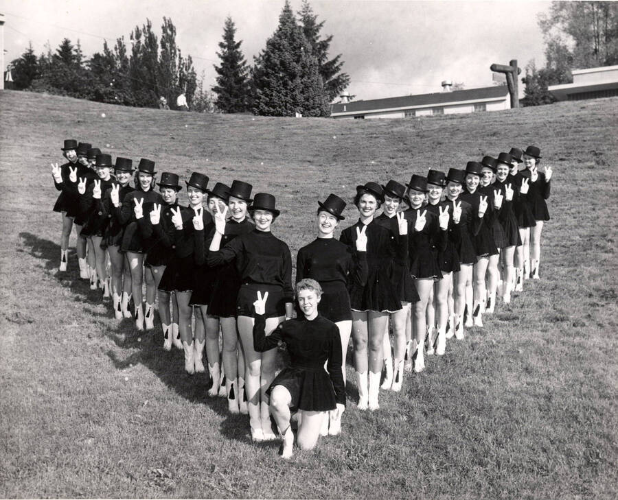 Vandalettes standing in a V formation pose for a photo in their uniforms.