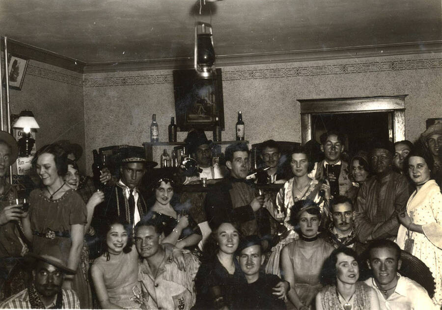 Students dressed in Gold Rush period costumes pose for a photo together in an unidentified house.