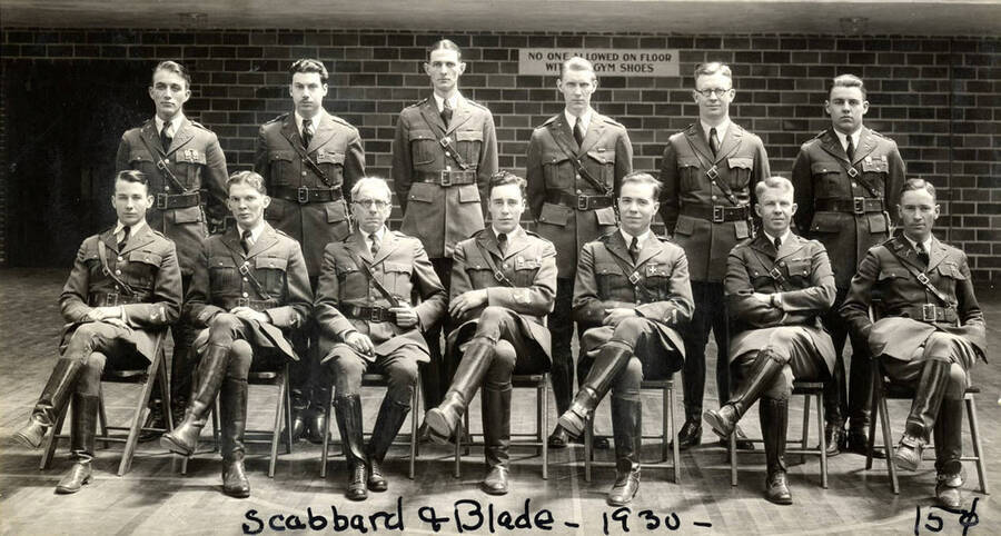 Members of the National Society of Scabbard and Blade pose for a photo together wearing their uniforms. Caption reads 'Scabbard & Blade ~1930~, 15 cents.'