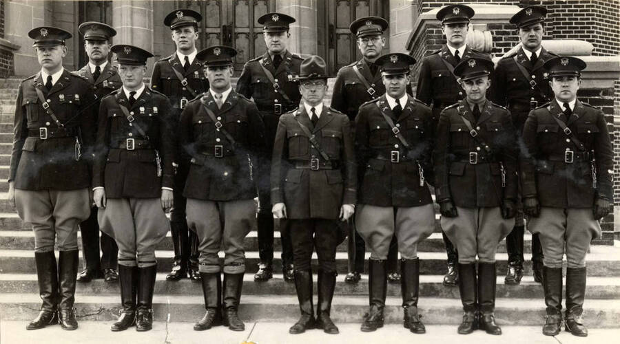 Members of the National Society of Scabbard and Blade pose for a group photograph in front of Memorial Gymnasium wearing their uniforms.