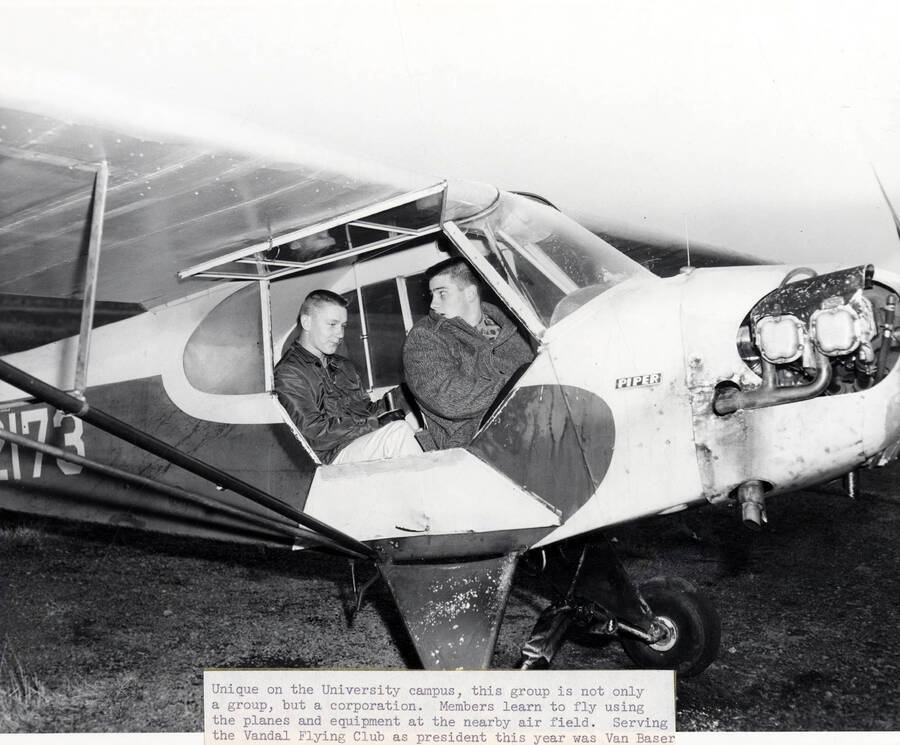 Two Vandal Flying Club members sit in a plane preparing for take off.