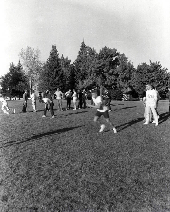 Men practice for intramural touch football game.