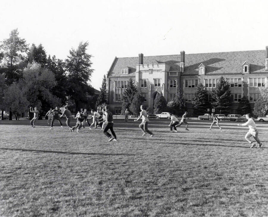 Groups of individuals play football on the Administration lawn.