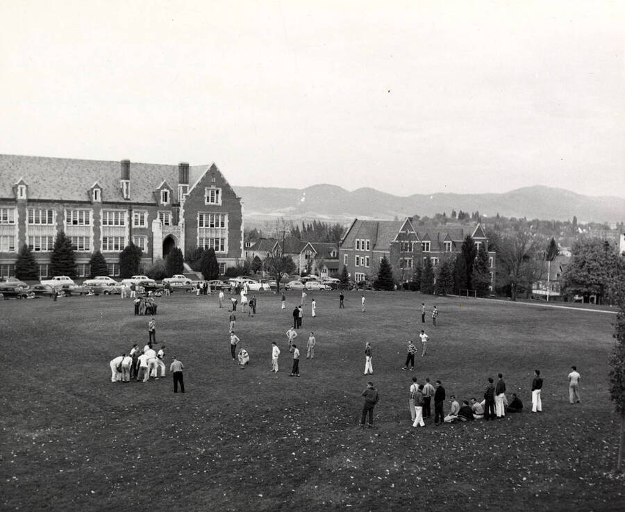 Teams and individuals practice for intramural touch football games on the Administration Lawn.