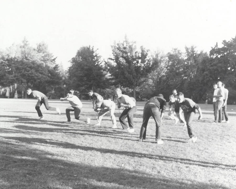 Men line up for a play during an intramural touch football game.
