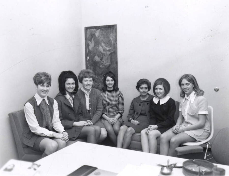 Panhellenic officers pose around a table for a group photograph.