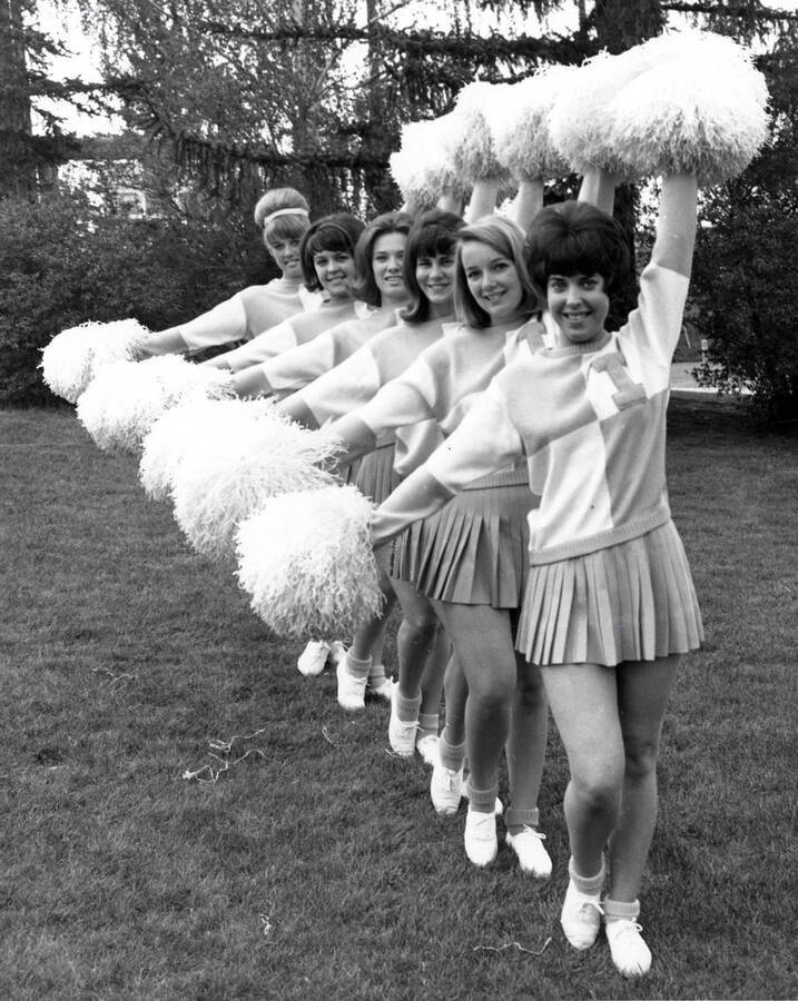 Pom-Pom Girls pose in a cheer formation outside on the Administration Lawn.