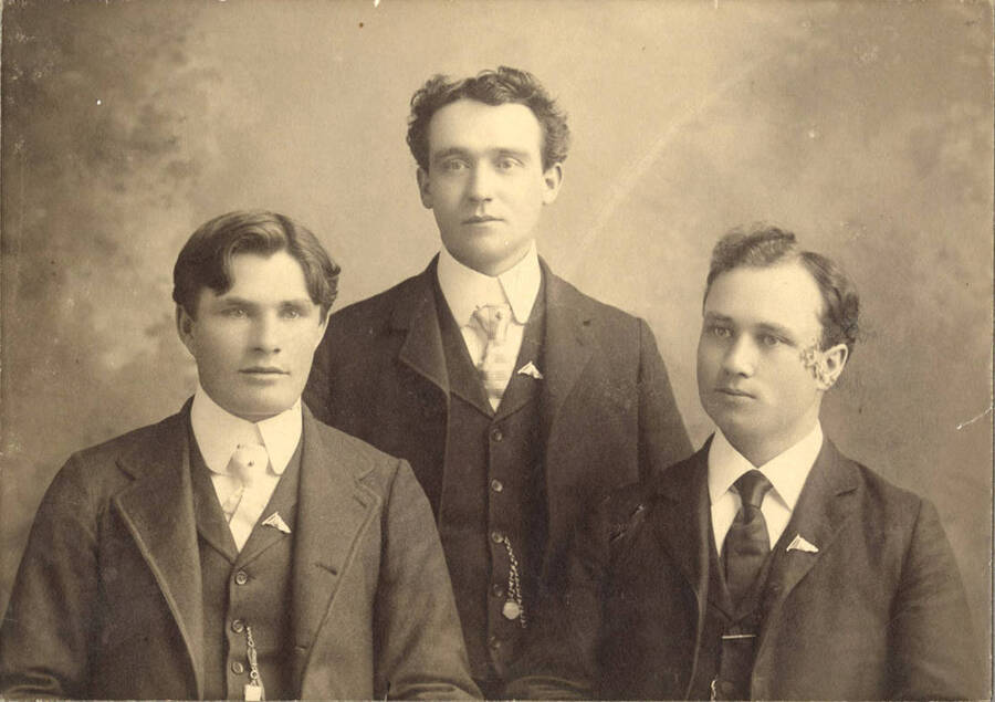 University of Idaho debate team members sit for a group picture. Individuals identified from left to right: C.W. Gibson, Miles Reed, Burton French.