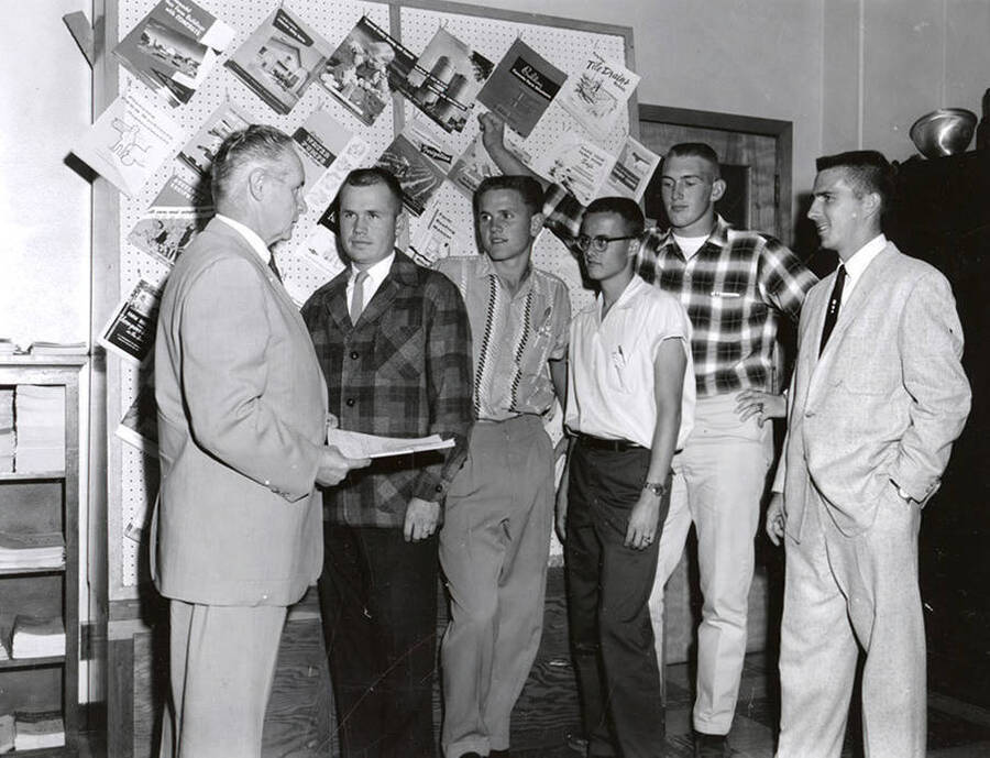 Professor J. W. Martin, head of Department of Agricultural Engineering, awards University of Idaho students scholarships from Washington Water and Power Company. Individuals identified as listed. Students: Ralph Boyd Brown, Lonny Roger Fox, Robert G. Haynes, John Robert Teague and James M. Malone