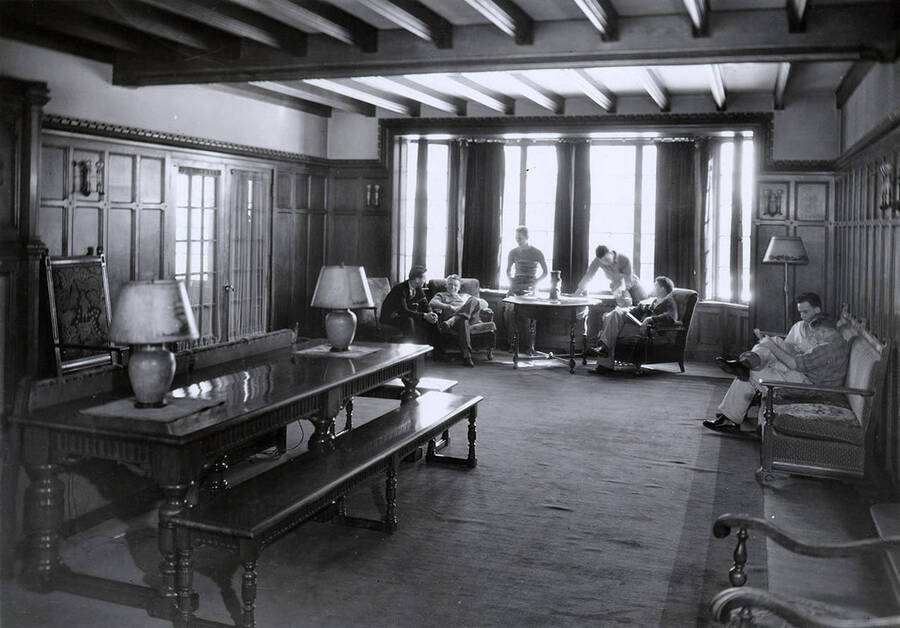 Students lounging around the living room at the Beta Theta Pi house, which is located on the northwest corner of Idaho and Elm Streets.
