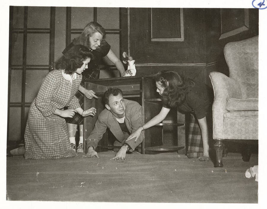 Students from l-r: Shirley Brandt as Joanna Trout, Margaret Payne as Mrs. Coade, John Rowe as Lob, and Polly Harris as Mabel Purdie. University of Idaho students rehears the desk scene for the play 'Dear Brutus.'