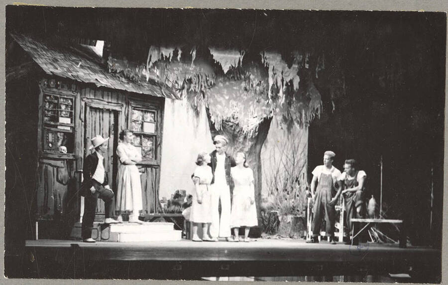 From l-r: Harry Dalva as Commodore, Marie Hargis as Mrs. Crochet, Larraine Cole as Topal, Normand Green as Dewey Crochet, Colleen Christensen as Evvie, Keith Keefer as Elmo, Kenneth Keefer as Fleece. Idaho drama students act out a group scene in the play, 'The Great Big Doorstep.'