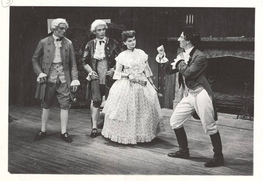 Performers from l-r: Gene Roth as Marlowe, Jack Muller as Hastings, Barbara Leach as Miss Neville and Dennis Savage as Tony Lumpkin. Tony Lumpkin puts his fists up to fight Marlowe in Idaho drama's production of 'She Stoops to Conquer.'