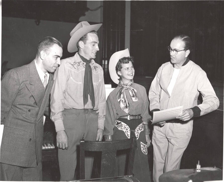 Performers from l-r: Ted Sherman, ?, Bonese Collins, Hall Macklin (musical score). Macklin explains the upcoming scene of the play, 'Sing, Senator, Sing' to performers in Idaho's drama department.