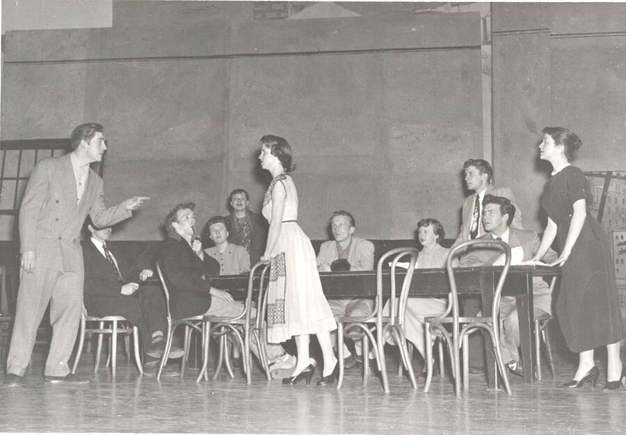 Students from l-r: Charles LaFollette, Tom Butera, Roger Styner, Mona Rosenau, Mary Thompson, Beverly Alger, Tom Wright, Marietta Cloos, Ted Torok, Marv Alexander, Sharon Henderson. Idaho drama students act out a group scene in the department's production of the play, 'Ladies of the Jury.'