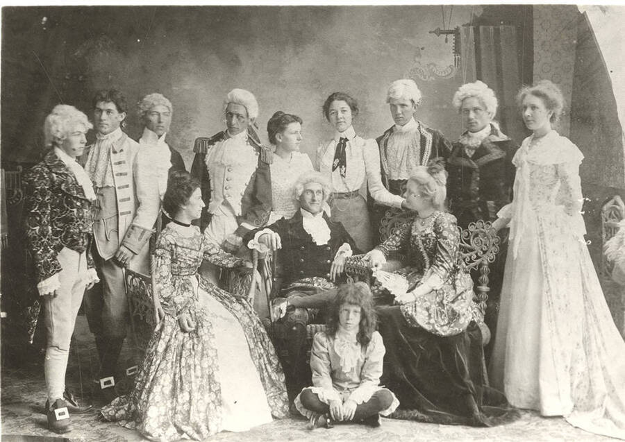 Students from left to right, standing: Ben Oppenheim, John McConnell, Andrew Peterson, Homer David, Nellie Ireton, Aurelia Henry, William Lee, B.L. French, Mable Martyn; seated: Edna Moore, Fred McConnell, Anna Edna Clayton; floor: Alfred Foster. Idaho drama students pose in costume for the school's production of "The Rivals."