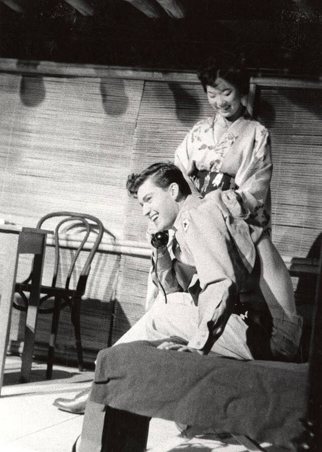 Ed Vandevort and Mary Tsudaka perform together on stage during a drama production of 'Teahouse of the August Moon'.