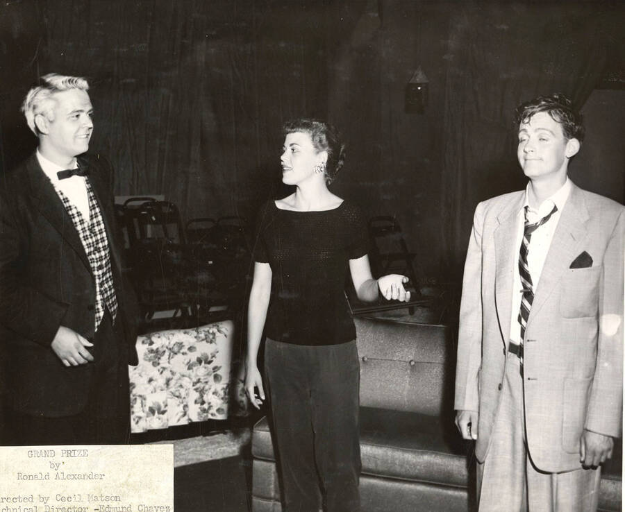 Claude Hanson, Jolene Williams, and Andy Tozier perform together on stage during a drama production of 'Grand Prize'.
