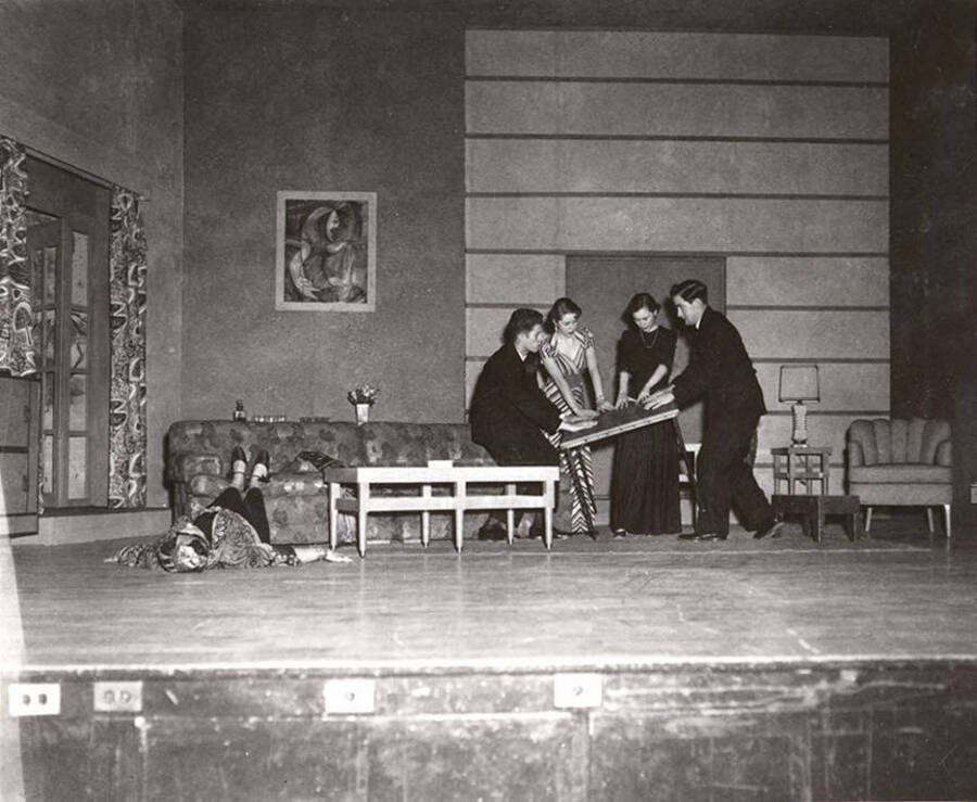 Shirley Lent, Gary Leaverton, Sharon Henderson, Rosemary Rowell, Stowell Johnson perform a group scene together during a drama production of 'Blithe Spirit'.