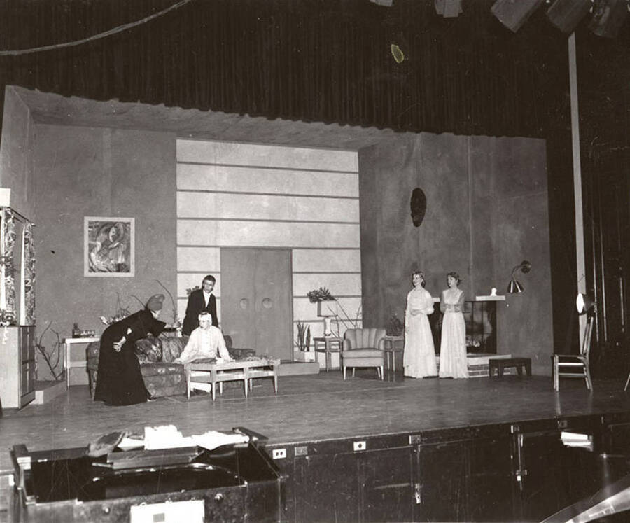 Shirley Lent, Mary Lou Lefors, Gary Leaverton, Lea Jensen, and Sharon Henderson perform a group scene during a drama production of 'Blithe Spirit'.