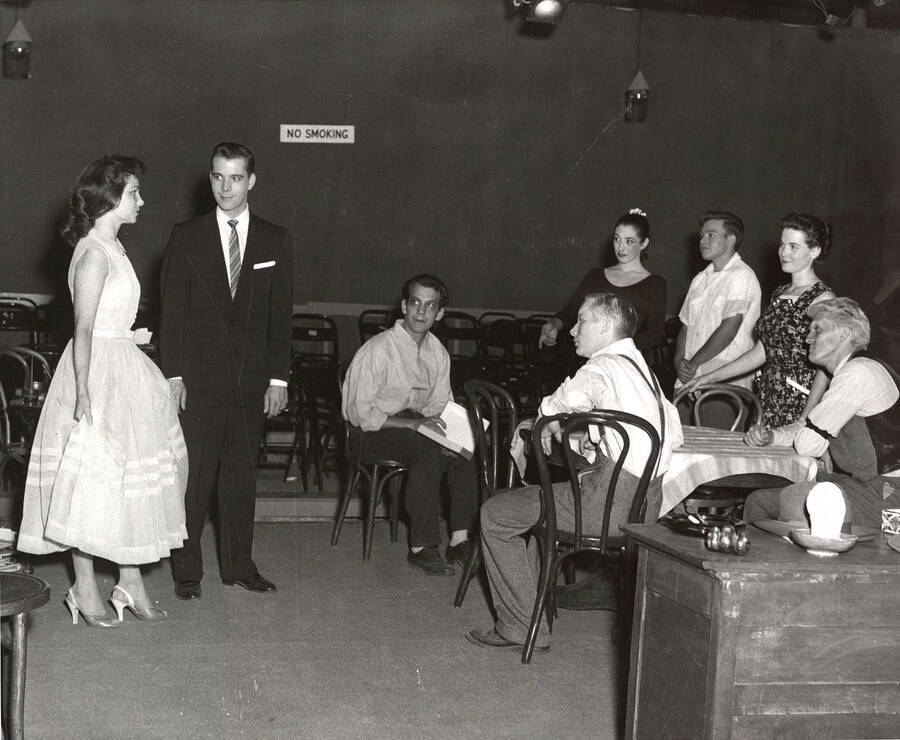 Unidentified actors performing a group scene during a drama production of 'You Can't Take It With You'.