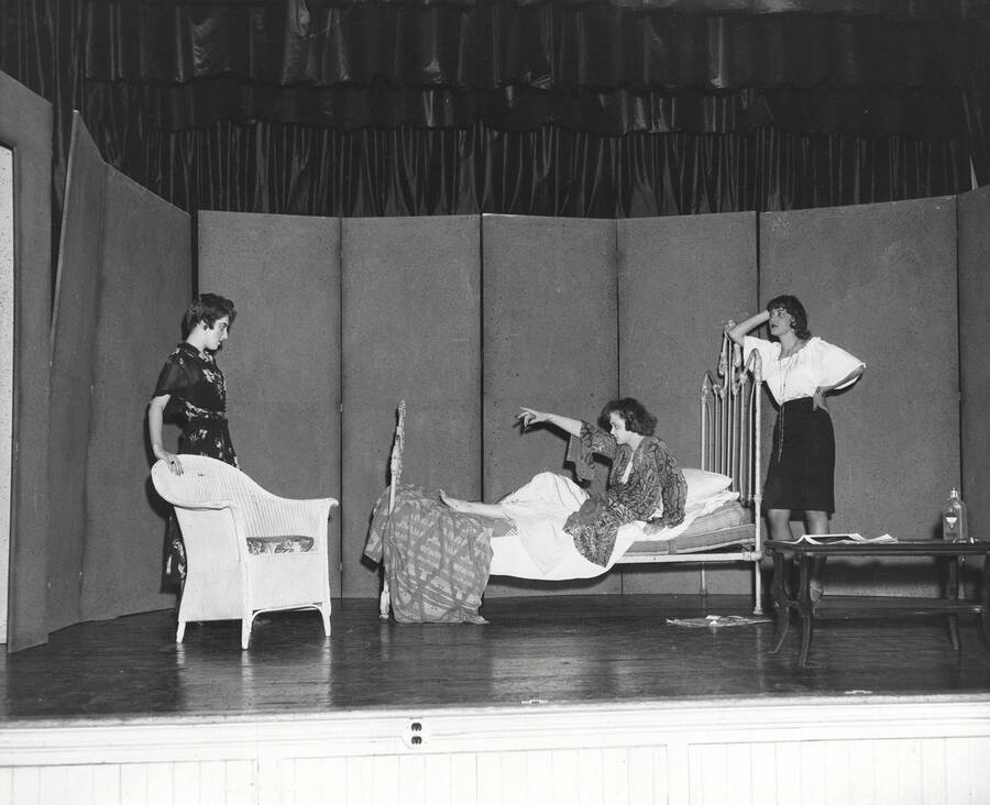 Three cast members perform a bedroom scene during a drama production of 'Mooney's Kid Don't Cry'. Cast includes Buzz McCabe and Carole Hurley.
