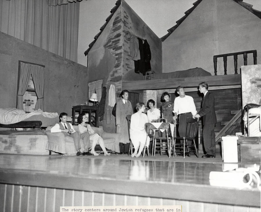 Cast members perform a group scene together during a drama production of 'Diary of Anne Frank'. Directed by Jean Collette. Cast includes Earl Pederson, Donna Morgan, Vicki Seibert, William Johnston, Gary Whitmore, Sally Willbanks, Diane Fawson, Angie Arrien, Lorenzo Nelson, and Sam Collet.