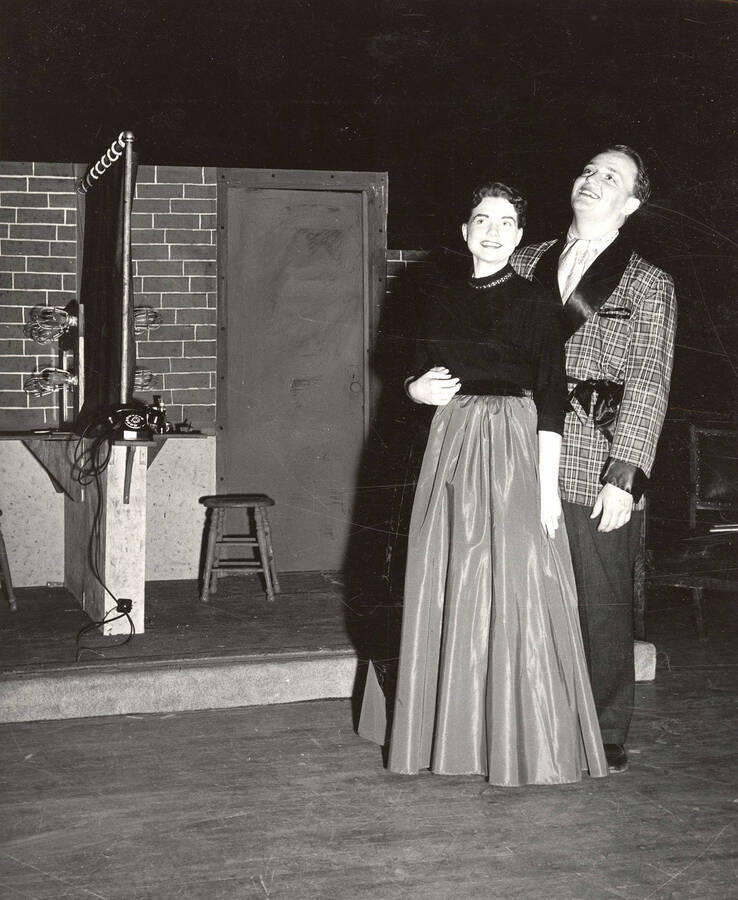 Joan Fischer and Lawrence Black on stage during a drama production of 'Kiss Me Kate'.