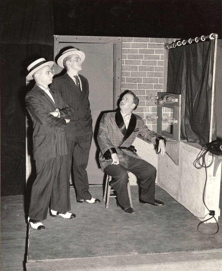 Nathan Yost, Clifford Cook and Lawrence Black performing a scene together during a drama production of 'Kiss Me Kate'.