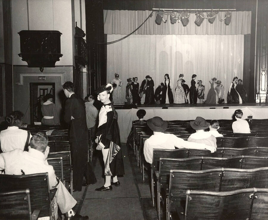 While awaiting stage calls during a full-dress rehearsal, actors play the part of the audience for a drama production of 'Kiss Me Kate'. Cast includes Larry Black, Joan Fisher, Bert Allen, Mary Jane Milbrath, Austin Bergen, Charles Tovey,  Corolie Davis, Dick Cripe, Dwight Patton, Cliff cook, Nathan Yost, Ed Vandervort, Wayne Benson, Graham Knox, Malcolm Alexander, Dick Katzenberger, Bob M