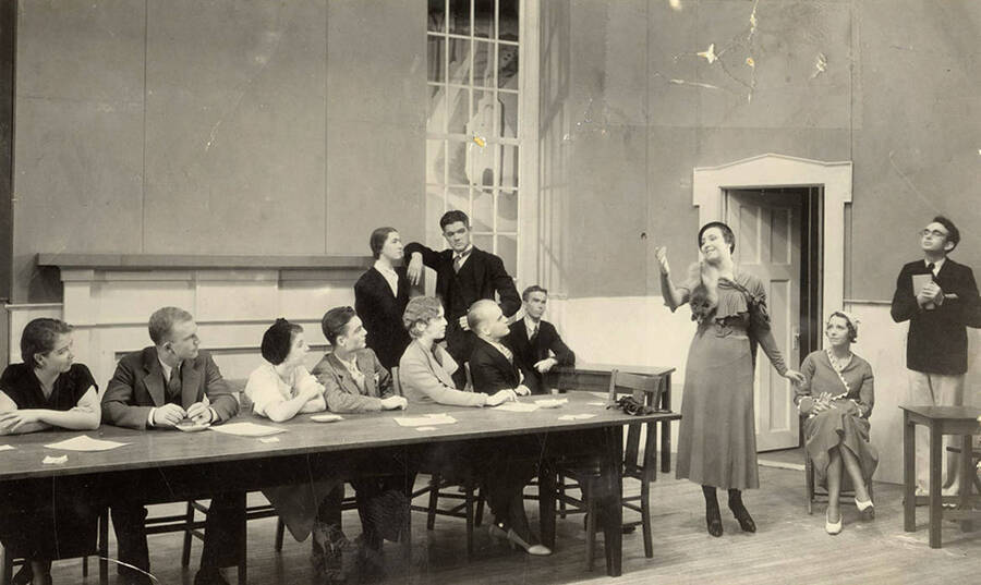 Mrs. Crane reciting verses to the jury, during the drama production of 'Ladies of the Jury.' Cast: Rosamond Tenney as Mrs. Crane, Edwin Ostroot as judge, Jack Blair and Casady Taylor as lawyers, Dorothy Menzies as defendant on trial, Naomi Randall as maid who testifies, etc.