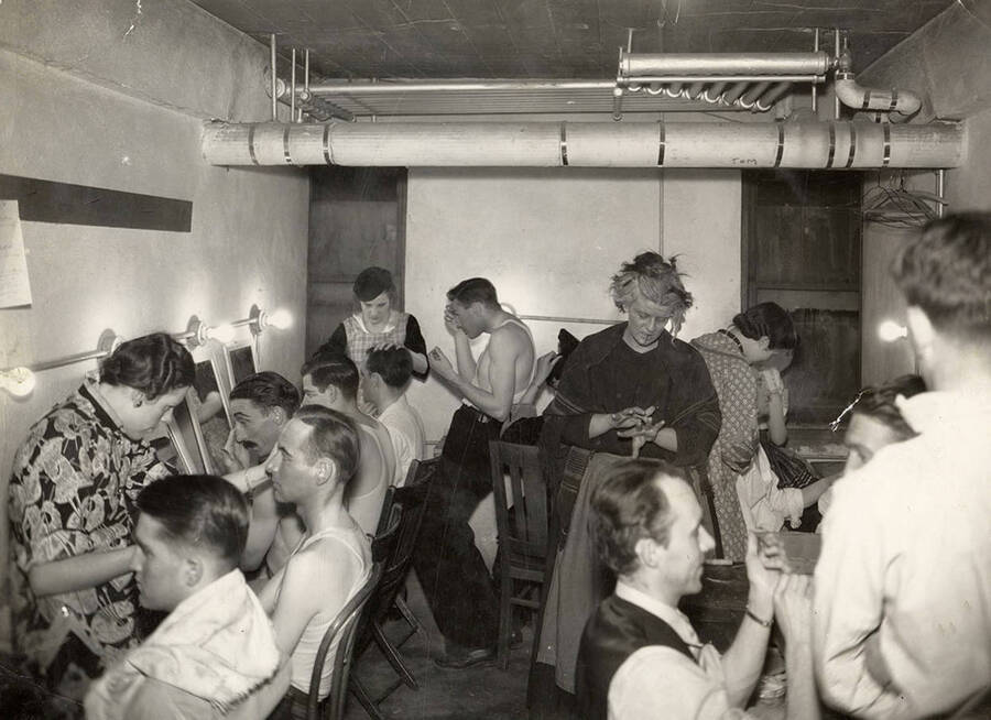 Men sitting in the make-up room during the drama production of 'Night Over Taos.' Cast: Eldred Stephenson as Pablo Montoya, Bill Cherrington and Don Tracy as Frederico and Felipe, Malcolm Renfrew as Martinex, Murva James as Diana, Marian Swanson as Dona Josefa and Erma Lewis as Veri