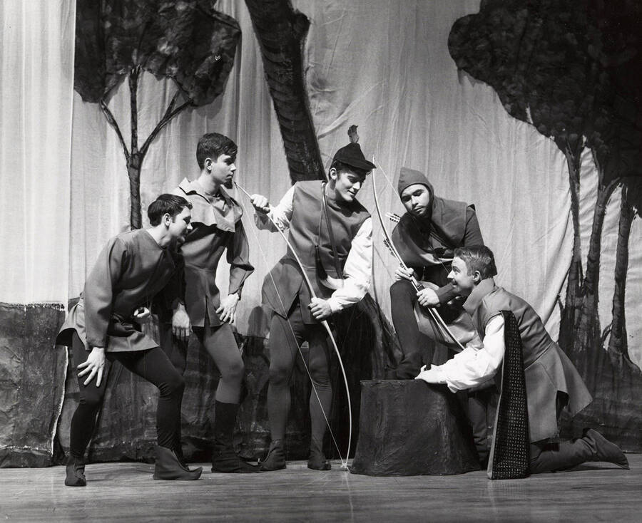 Men huddle on stage with bows during the children's theatre production of 'Adventures of Robin Hood.'