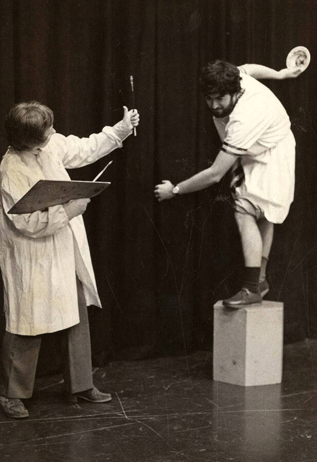 Judy Chavez, playing Penelope Sycamore, painting a portrait of Kenton Bird, playing Mr. DePinna, during the Moscow Community Theatre production of 'You Can't Take it with You.'