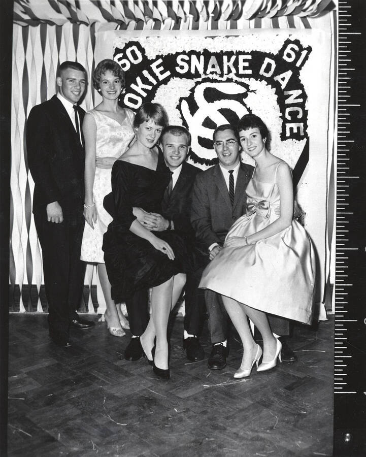 Three couples pose for a photo during the Sigma Nu formal dance.
