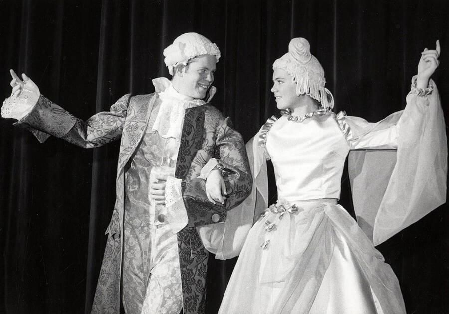A man and woman link arms during the drama production of 'The Taming of the Shrew.'