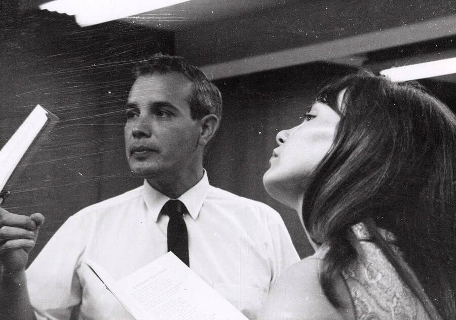 Ed Chavez and a woman look away during a drama production.