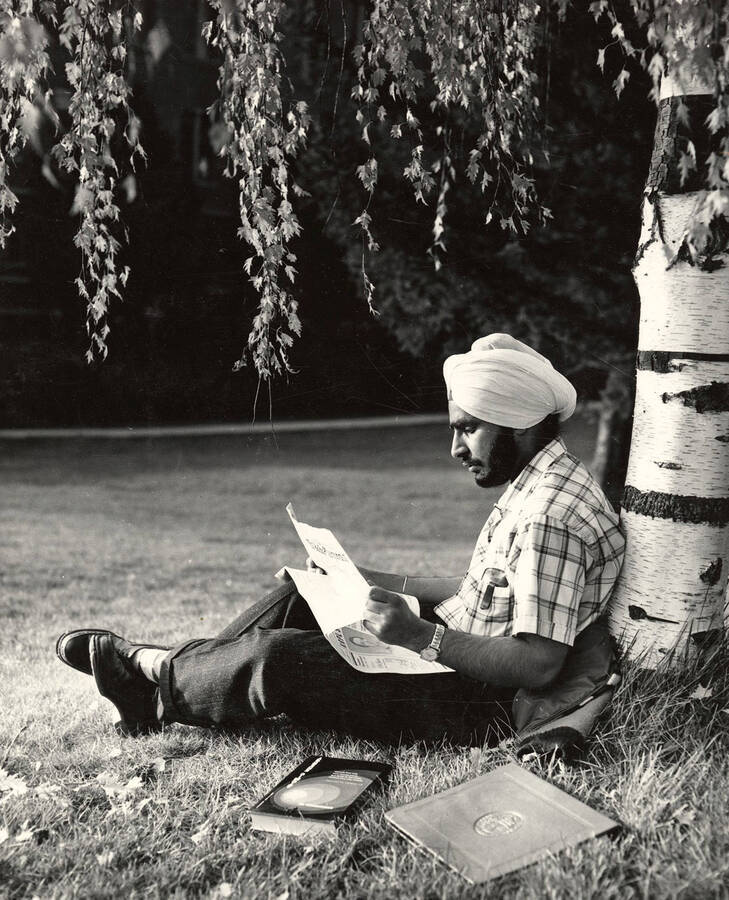 Trilochan Singh Bains, from Punjab, India, sits under a tree studying.