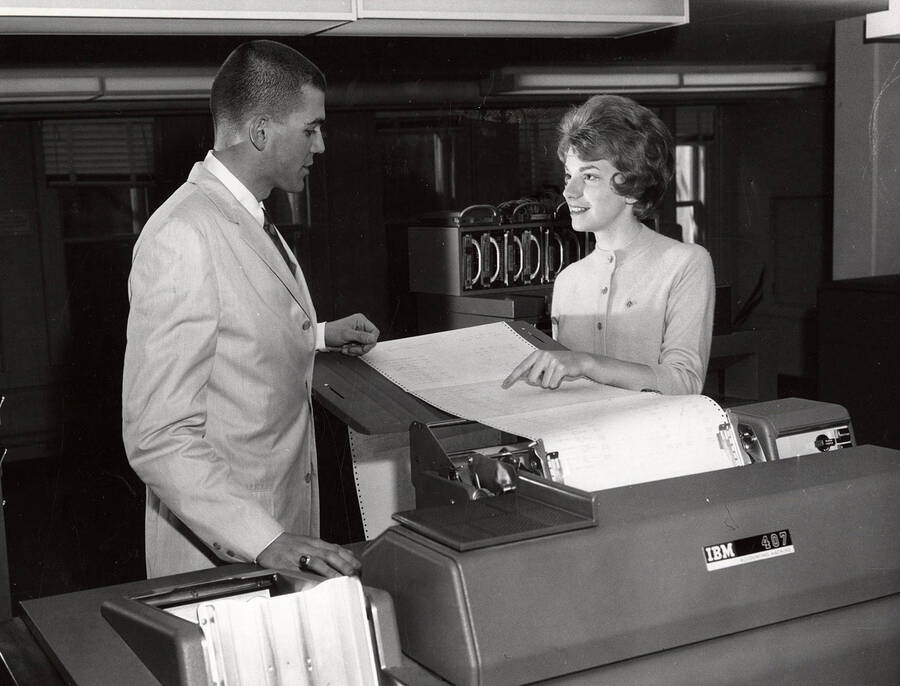 University of Idaho students Carl Grover Berry and Dana Andrews work with an IBM 407 accounting machine.