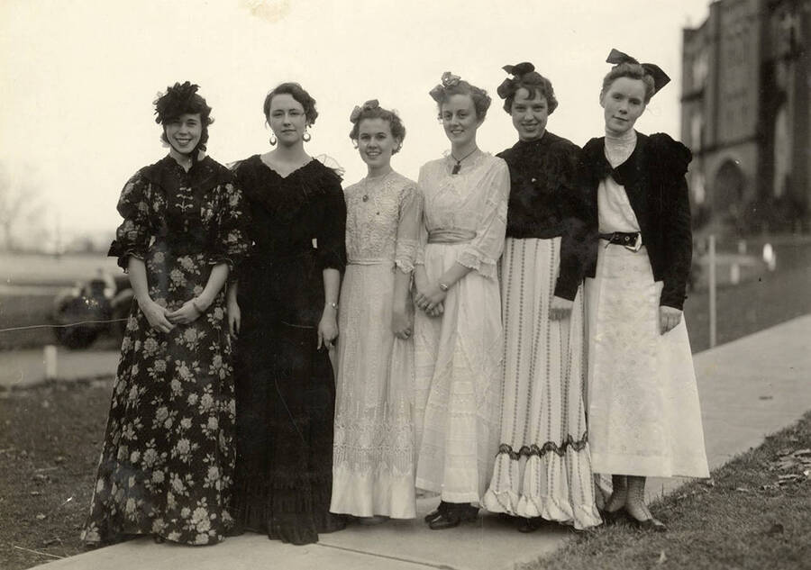 Five Gamma Phi Beta girls pose in early 20th-century period costumes.