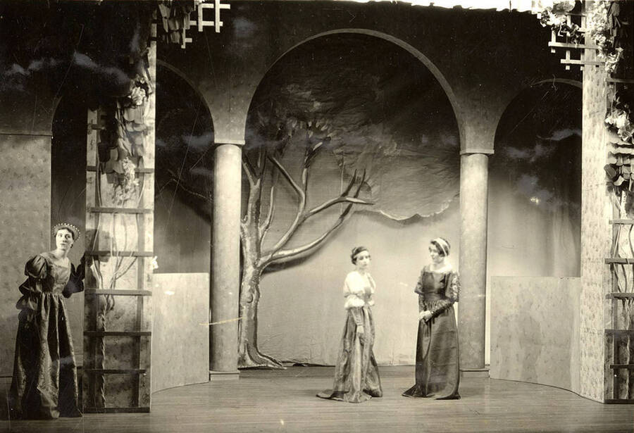 Scene from the University of Idaho drama production of 'Much Ado About Nothing.' Three women can be seen dressed in costume, and conversing on stage.