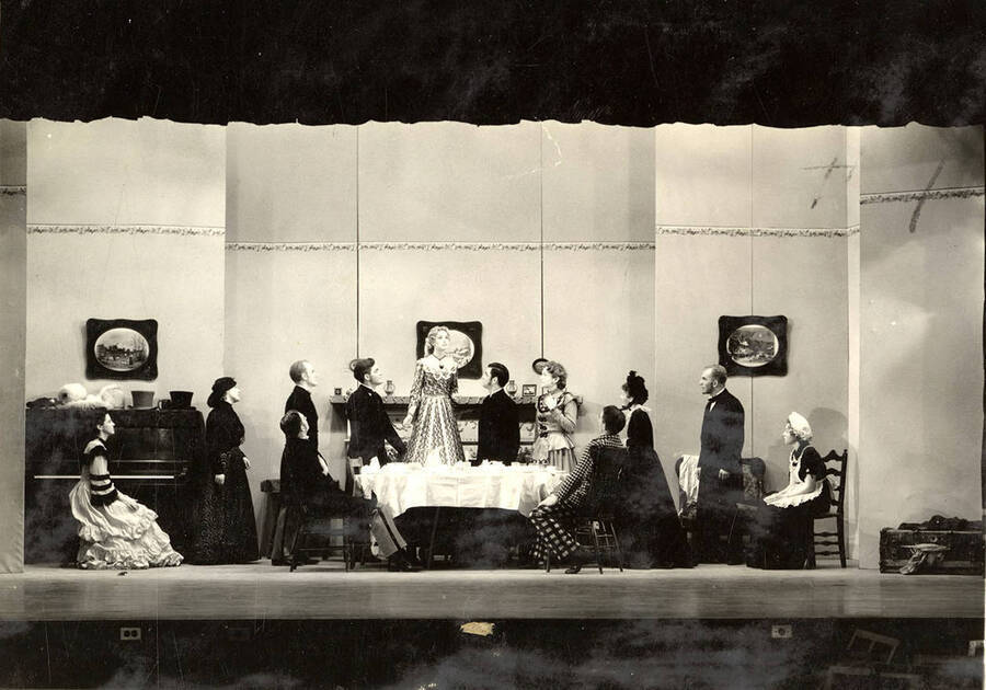 Scene from the University of Idaho drama production of 'Trelawny of the Wells.' In this scene, Rose Trelawny is saying goodbye. Members of the cast include Alberta Bergh Utt as Rose Trelawny, Robert Herrick as Tom Wrench, Marion Dresser as Imogen, Clarence Anderson as Colpoys, Jean Ricker as Avonia Bunn and Raphael Gibbs as Sir Gower.