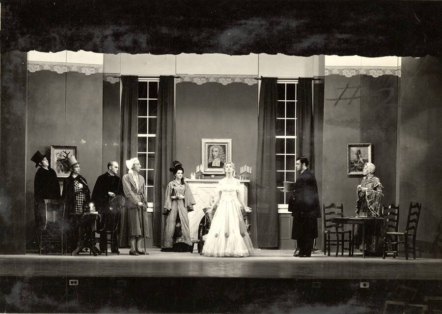 Scene from the University of Idaho drama production of 'Trelawny of the Wells.' In this scene, Rose Trelawny decides to go 'back to Wells' with her old friends. Members of the cast include Alberta Bergh Utt as Rose Trelawny, Robert Herrick as Tom Wrench, Marion Dresser as Imogen, Clarence Anderson as Colpoys, Jean Ricker as Avonia Bunn and Raphael Gibbs as Sir Gower.