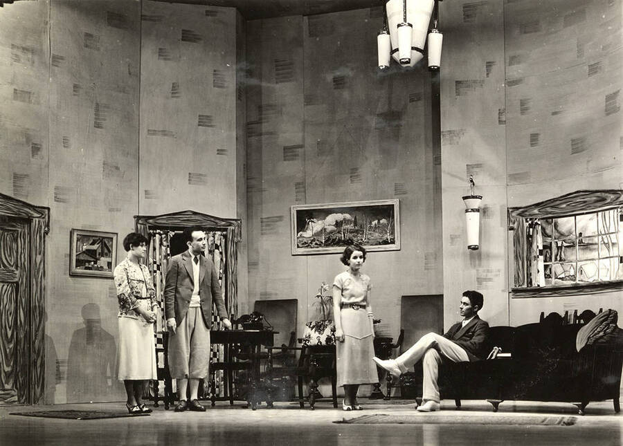 Group scene from the University of Idaho drama production of 'A Paragraph for Lunch.' Members of the cast include Grace Eldridge, John Thomas, Raphael Gibbs, Harry Robb, Margaret Moulton, Howard Altnow, Betty Brown, Lucile Moore, Elinor Jacobs, John Milner, Marthalene Tanner, and Casady Taylor.