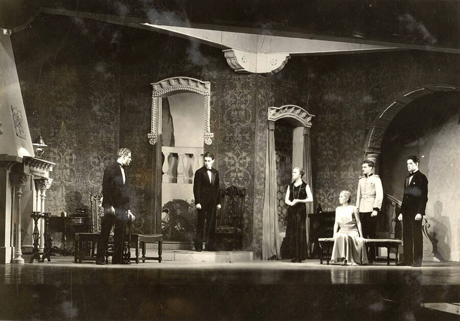 Scene from the University of Idaho drama production of 'Death Takes a Holiday.' Members of the cast include Lionel Campbell as Prince Sirki, Bertha Moore as Grazia, Clayne Robison as Duke Lambert, Winfred Janssen as Eric Fenton, Howard Altnow as Corrado, Raphael Gibbs as Baron Cesarea, and Casady Taylor as Major Whitred.